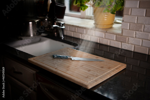 Knife and cutting board in kitchen 