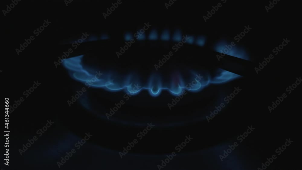 Moving flames of gas in gas cooker. Blue fire on stove in dark. Moving flames of gas in gas cooker. Blue fire on stove in dark.