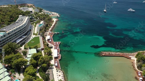Aerial drone video from famous celebrity sandy beach of Astir or Asteras in south Athens riviera with turquoise clear sea, Vouliagmeni, Greece