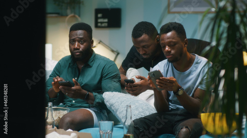 Black guys making and discussing online bets during match