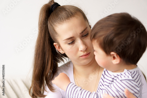 Worried young foster care parent mother comforting solacing embrace adopted little child daughter give care and protection at home, loving concerned adult mom hug sad small girl consoling kid concept