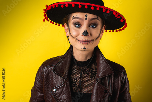 Close-up portrait of Kalavera Katrina close up showing various emotional body gestures, face, in sambrero, on yellow background, looks straight, sideways. Dia-de -los -muertos. Day of death. Halloween