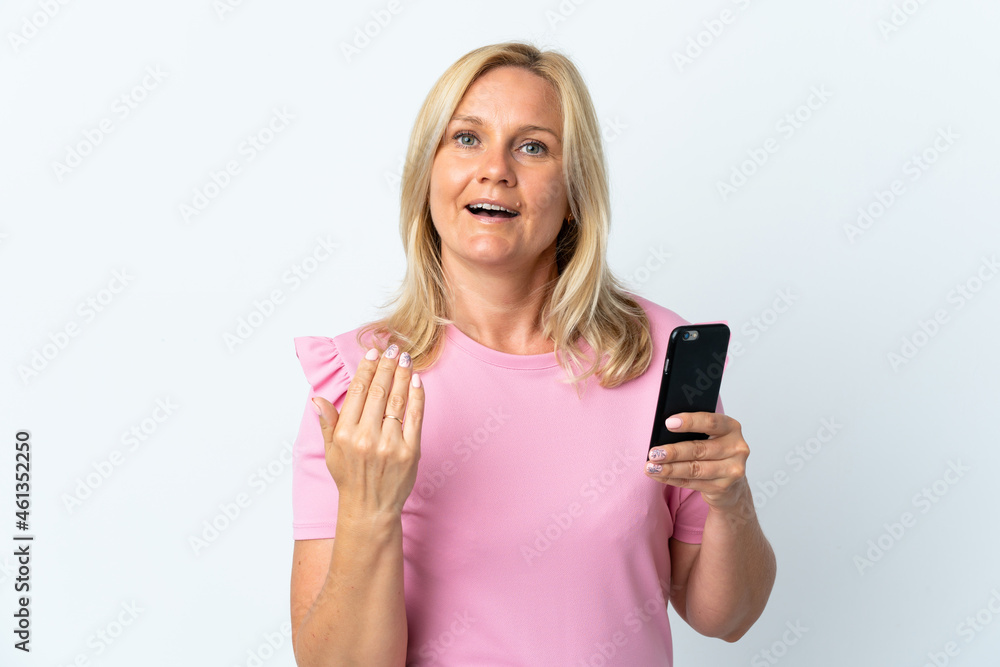 Middle age using mobile phone isolated on white background inviting to come with hand. Happy that you came Middle age using mobile phone isolated on white background inviting to come with hand. Happy that you came