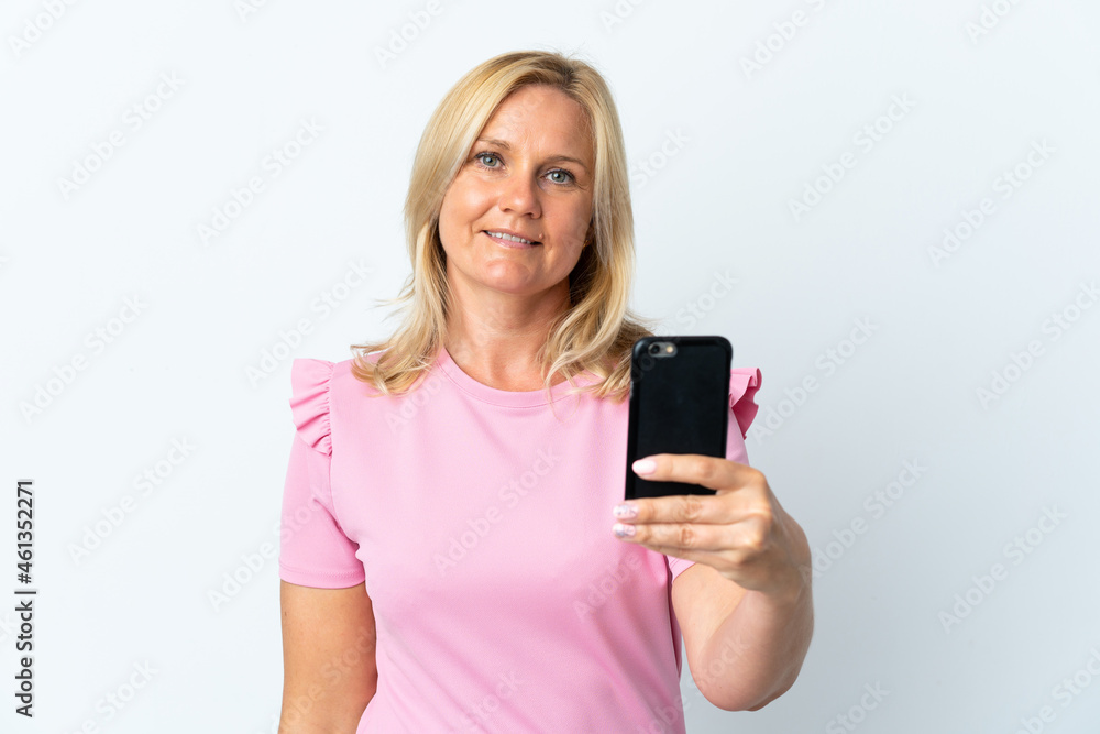 Middle age using mobile phone isolated on white background with happy expression Middle age using mobile phone isolated on white background with happy expression