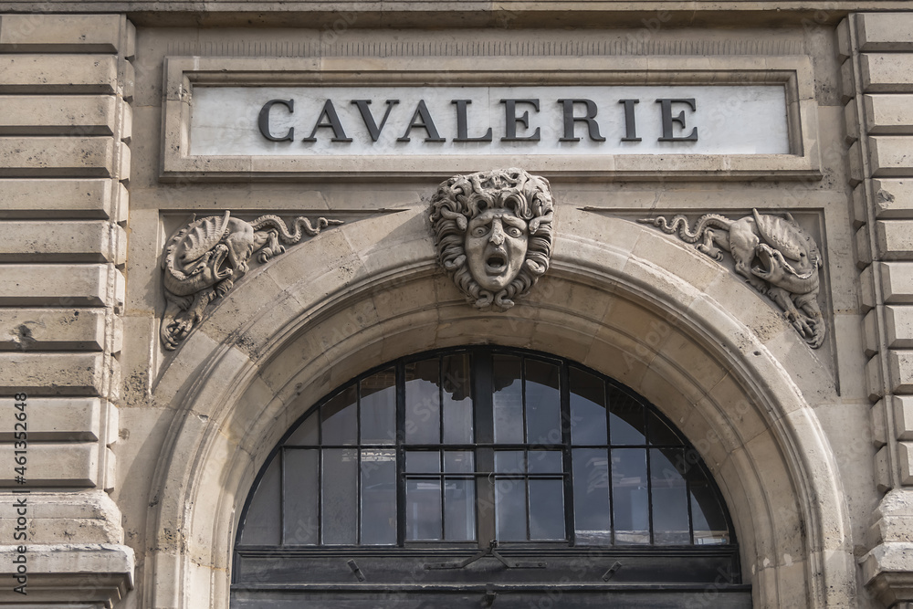 Architectural fragment of the facade of the military school (Ecole Militaire) founded in 1750 in Paris. Cavalry (Cavalerie) building. Paris, France.