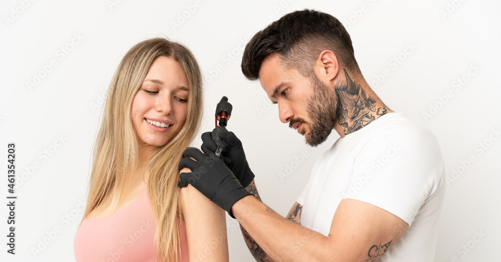 man tattooing a girl over isolated background man tattooing a girl over isolated background