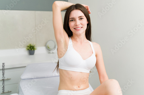 Wall Mural Caucasian woman showing her smooth armpit