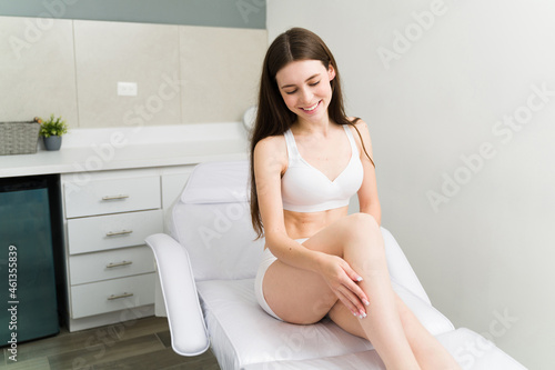 Excited woman with her epilation procedure photo