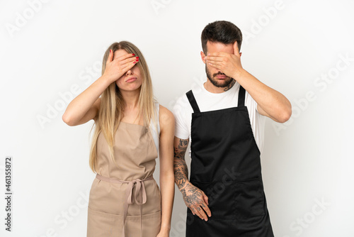 Restaurant waiter over isolated white background covering eyes by hands. Do not want to see something