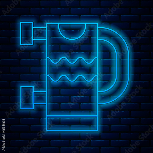 Glowing neon line Heated towel rail icon isolated on brick wall background. Vector