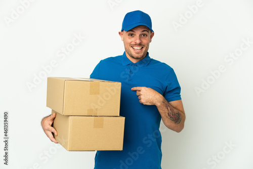 Delivery caucasian man isolated on white background with surprise facial expression © luismolinero