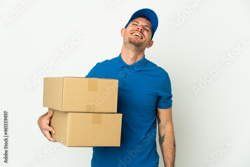 Delivery caucasian man isolated on white background laughing © luismolinero