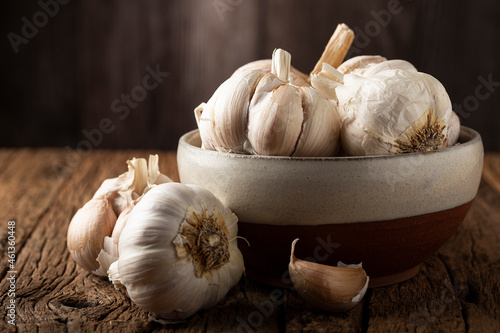 Garlic bulb and garlic cloves on the wooden table. photo