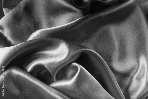 Elegant bright satin with waves. Fabric backdrop, view from above. Luxury cloth texture. Prefect as an abstract background with copy space, close-up.