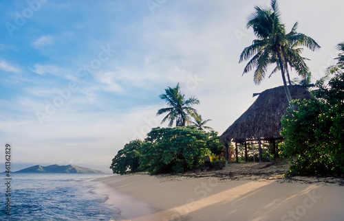 Traditioanal hutt on beach at waters edge at Mana Island photo