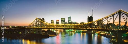 Panorama of Storey Bridge lite up at night over Brisbane River