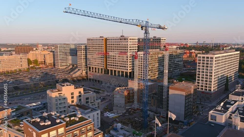 Helsinki.Finland-August 30.2021: Beautiful drone shot of a construction site in Helsinki Finland. Nordic architecture. Modern buildings and cranes. Camera slowly moving sideways. photo