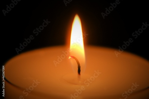 Candle on black background..Candle flame.Candle background. Burning candle in the dark