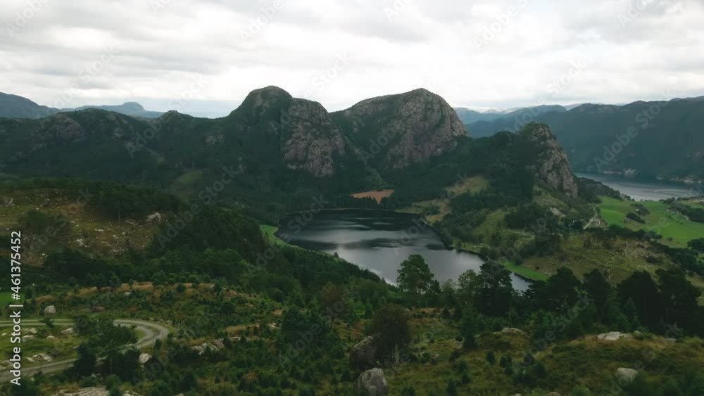Aerial View Of Calm Lake From Above Fir Tree Farm On Mountain Hills With Crag. - pullback Aerial View Of Calm Lake From Above Fir Tree Farm On Mountain Hills With Crag. - pullback