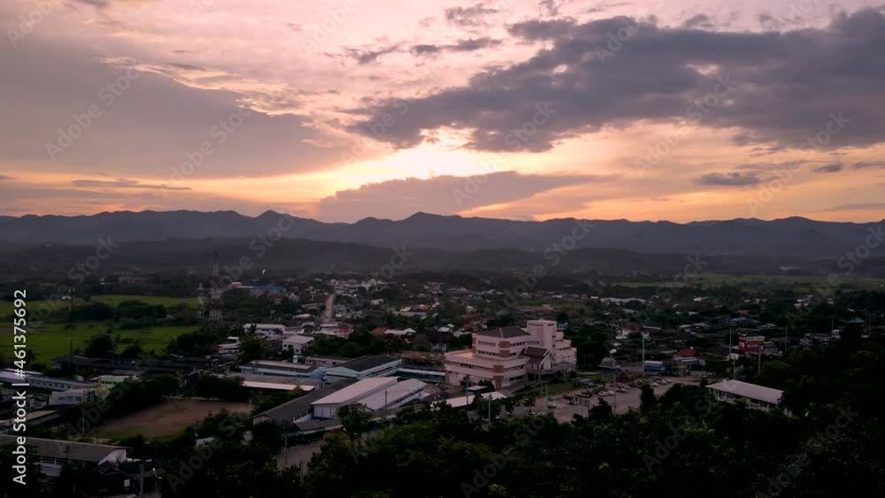 Aerial view crane shot from the sunset sky over the town to behind the forest in Mae Hong Son province Northern Thailand. Aerial view crane shot from the sunset sky over the town to behind the forest in Mae Hong Son province Northern Thailand.