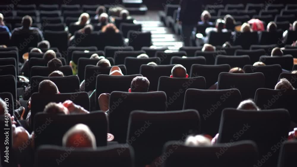 Audience in a movie theater watching a film - big cinema Audience in a movie theater watching a film - big cinema