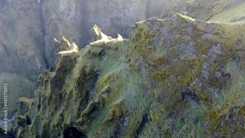 Reveal of steep mountain walls covered in sun rays photo