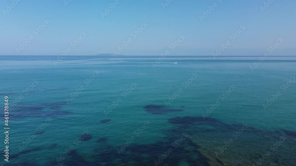 Calm deep blue ocean sea and blue sky, Greek Island bay San Stefonos Corfu, drone View. Calm deep blue ocean sea and blue sky, Greek Island bay San Stefonos Corfu, drone View.