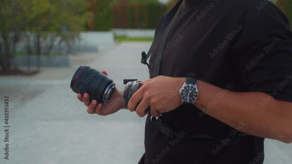 Man mounting lens to a camera, Checking camera sensor, Changing Camera lens Man mounting lens to a camera, Checking camera sensor, Changing Camera lens