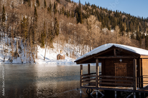 Winter gazebo very close to the winter lake on a sunny day. Rest on the spring Red Key, a bath by the lake, a trip to the mountains and springs. © Aleksey