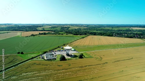 Chilbolton Observatory astronomy radio telescope dish array aerial orbit left above farming field photo