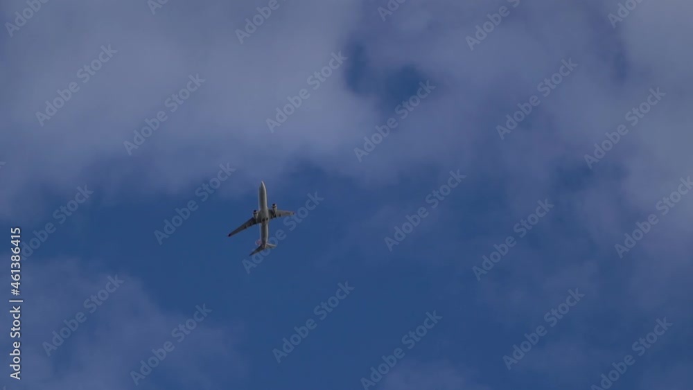 Commercial aircraft flying above in fluffy clouds, camera motion view Commercial aircraft flying above in fluffy clouds, camera motion view