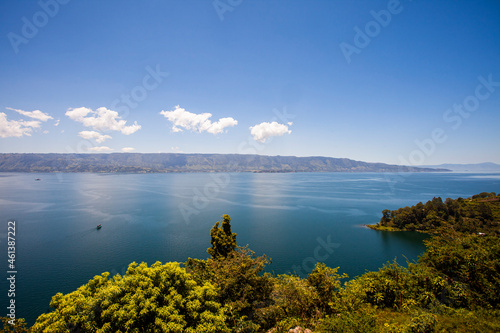 Fototapeta Naklejka Na Ścianę i Meble -  Lake Toba is a large natural lake in North Sumatra, Indonesia, located in the caldera of Mount Supervolcano. View from Parapat. This lake has a length of 100 kilometers, a width of 30 kilometers. 