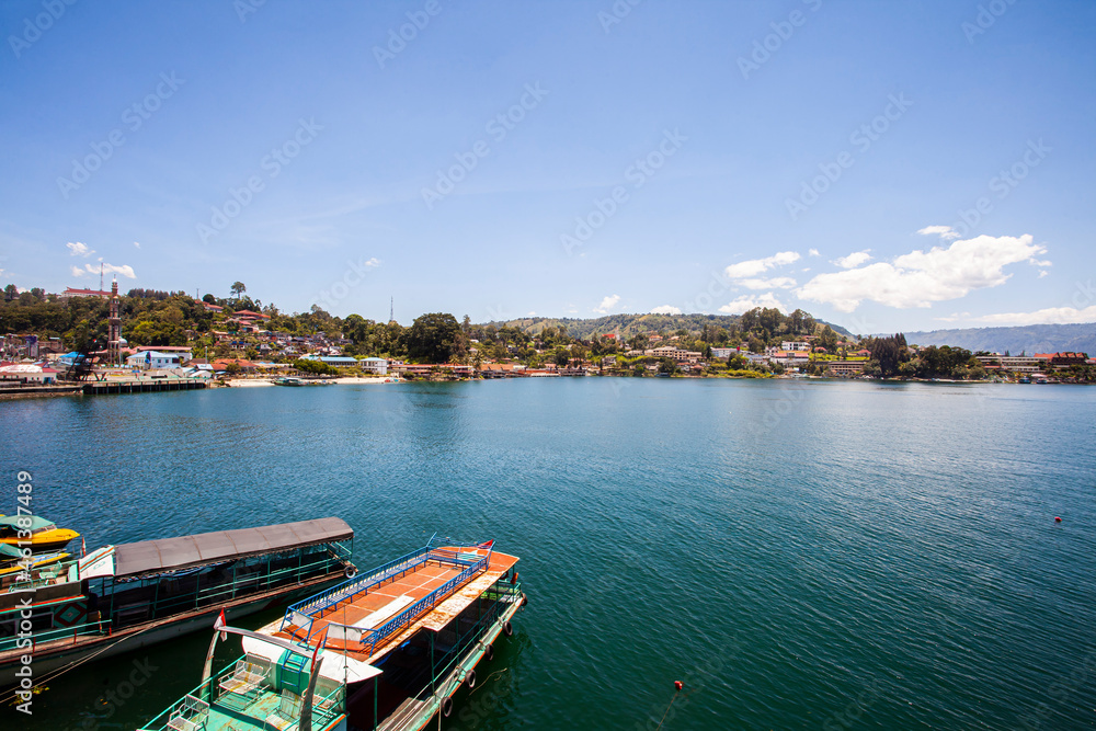 Lake Toba is a large natural lake in North Sumatra, Indonesia, located in the caldera of Mount Supervolcano. View from Parapat. This lake has a length of 100 kilometers, a width of 30 kilometers. 