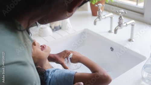 Slow motion of boy washing up with his mother