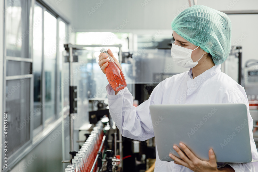 Quality control and food safety inspector test and check product contaminate standard in the food and drink factory production line with hygiene care.