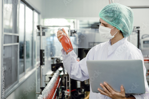 Quality control and food safety inspector test and check product contaminate standard in the food and drink factory production line with hygiene care. photo