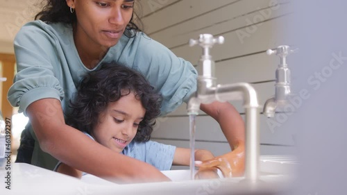 Slow motion of mother and son washing hands