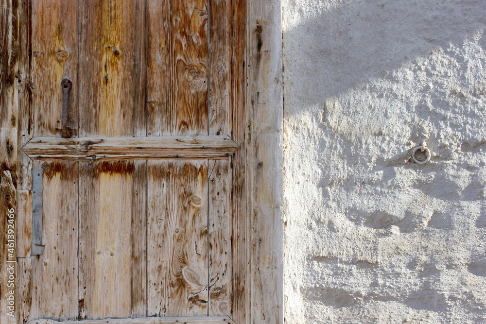 old wooden door adobe wall in the countryside old wooden door adobe wall in the countryside