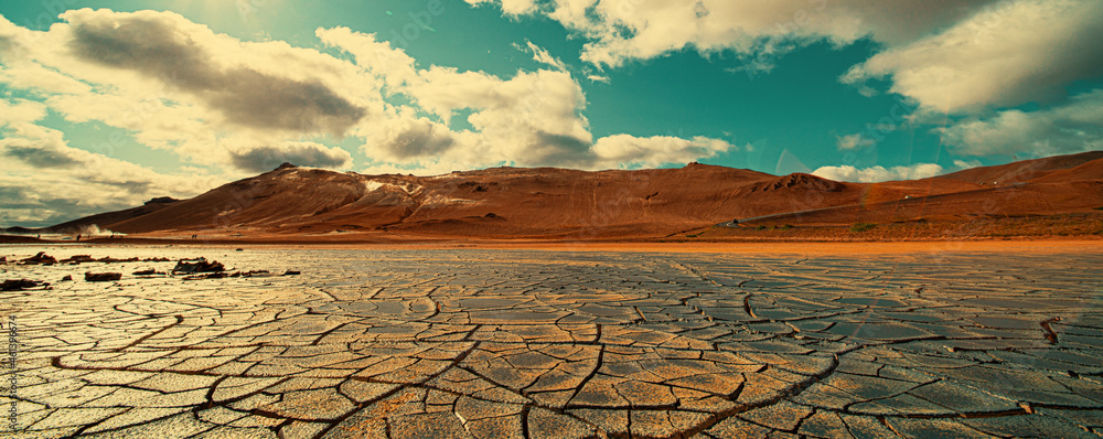 Cracked earth at the site of a dried  lake. Global climate change concept - obrazy, fototapety, plakaty 