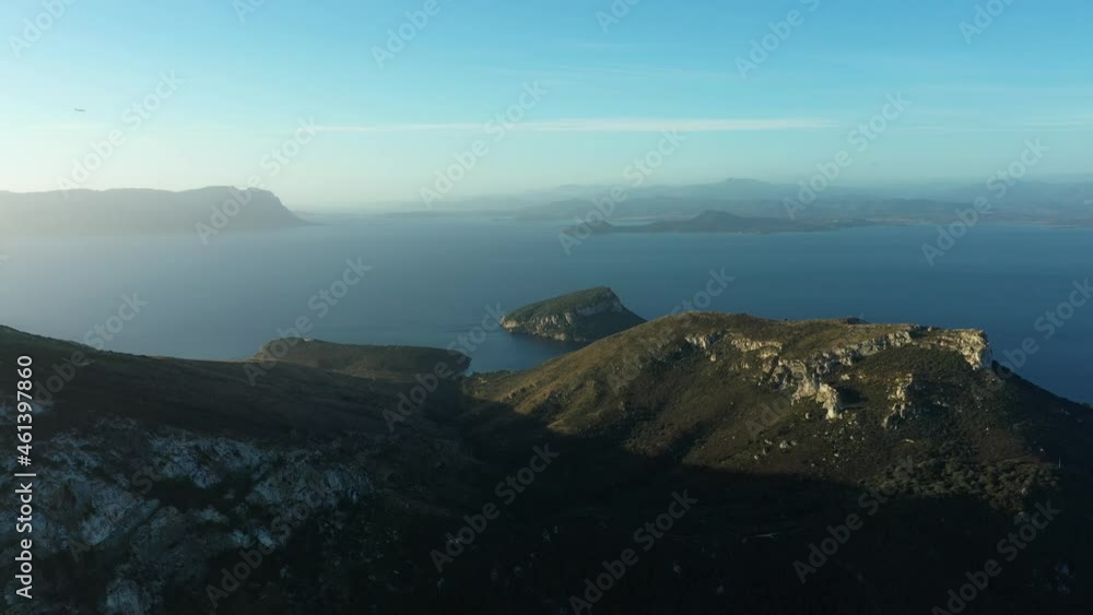 View from above, stunning aerial view of the Golfo Aranci Promontory during a stunning sunrise. Figarolo and Tavolara island in the distance. Sardinia, Italy. View from above, stunning aerial view of the Golfo Aranci Promontory during a stunning sunrise. Figarolo and Tavolara island in the distance. Sardinia, Italy.