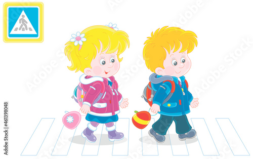Cheerful little schoolboy and schoolgirl with backpacks going to their school and crossing a road on a zebra crossing, vector cartoon illustration isolated on a white background