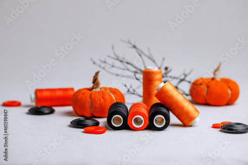 A set for creativity for Halloween in black and orange colors. Decorative threads and buttons on sacking. Preparation for the holiday.