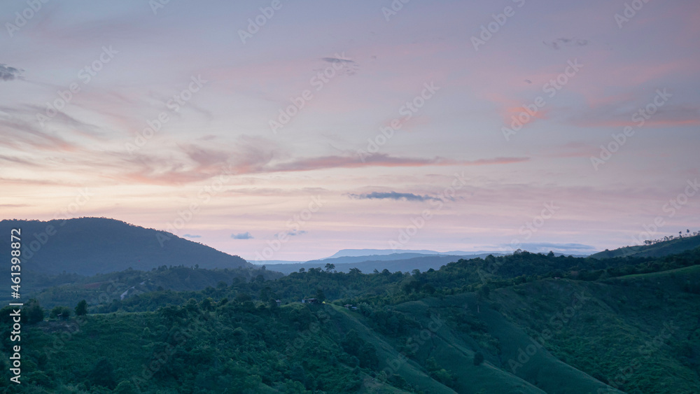 Obraz premium Intricate mountain scenery in the morning when the sun is rising. The wind blows trees and grass. Blown by the wind. Nature on the mountain in the morning. Fresh air.