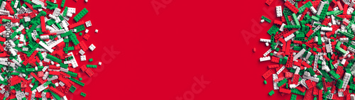 Double border of red green and white toy bricks on red background with place for your text. Toy bricks in traditional christmas colors. Educational toy for children. 3d rendering