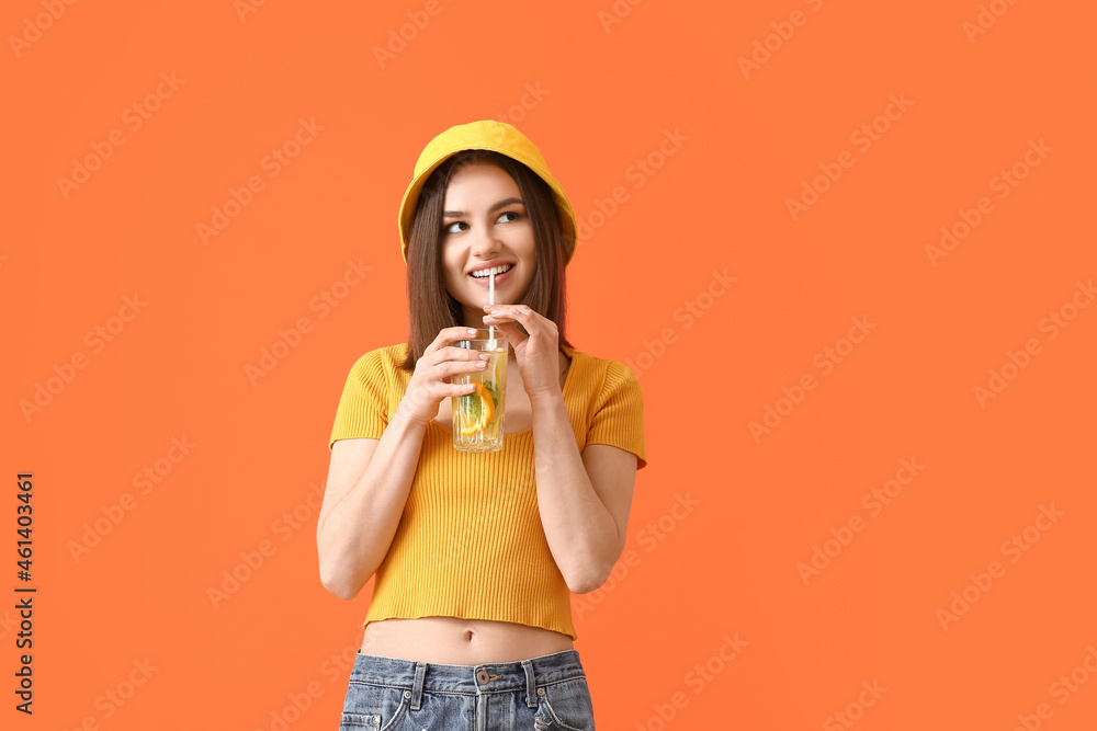 Beautiful young woman drinking fresh lemonade on color background Beautiful young woman drinking fresh lemonade on color background