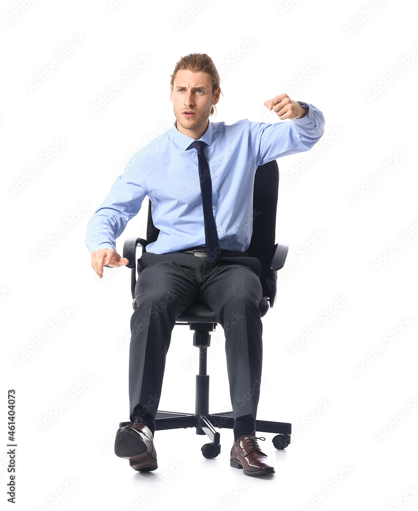 Young man with imaginary steering wheel sitting on chair against white background Young man with imaginary steering wheel sitting on chair against white background