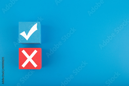 True and false symbol on blue and red cubes against bright blue background with copy space