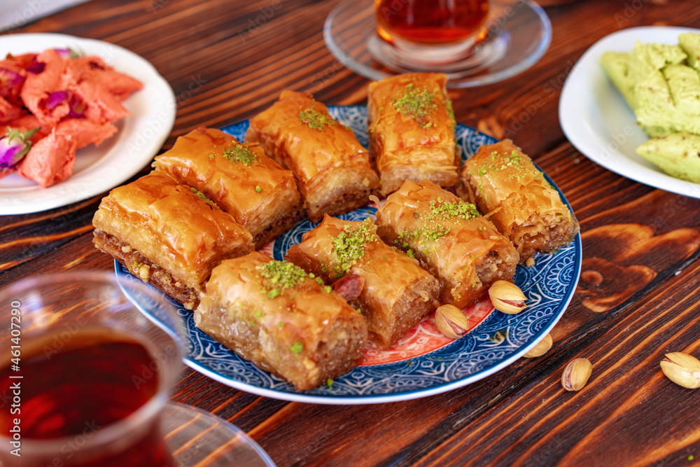 Turkish sweet baklava with Turkish tea on wooden background Turkish sweet baklava with Turkish tea on wooden background