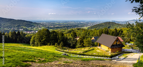 Fototapeta Naklejka Na Ścianę i Meble -  Panoramic view of northern slope of Little Beskids in Beskidy Mountains with wooden village house Targanice village near Andrychow in Lesser Poland