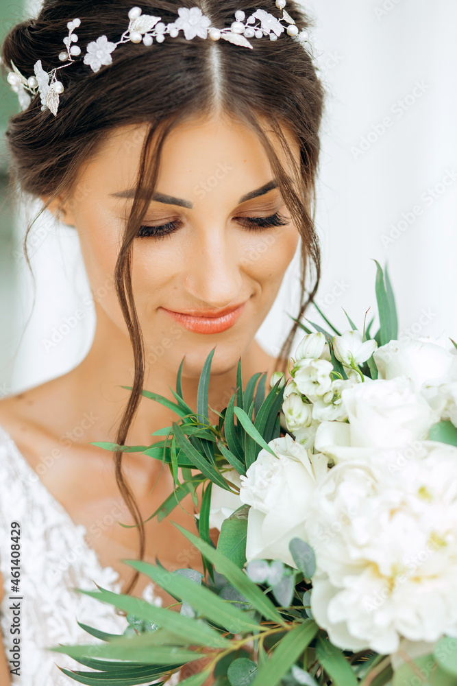 Portrait of a elegant bride with a bouquet of flowers